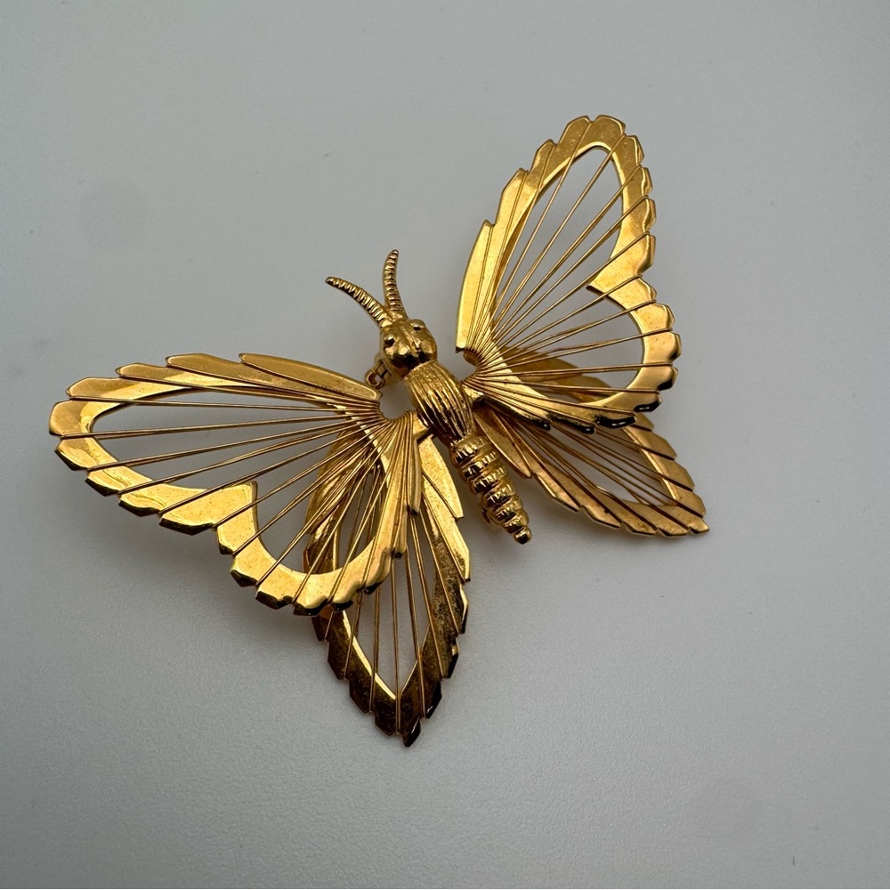 Monet gold-tone metal butterfly brooch filigree or "harp-like" wire wing design